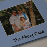 A family's personal photo book of their adoption, titled The Abbey Road